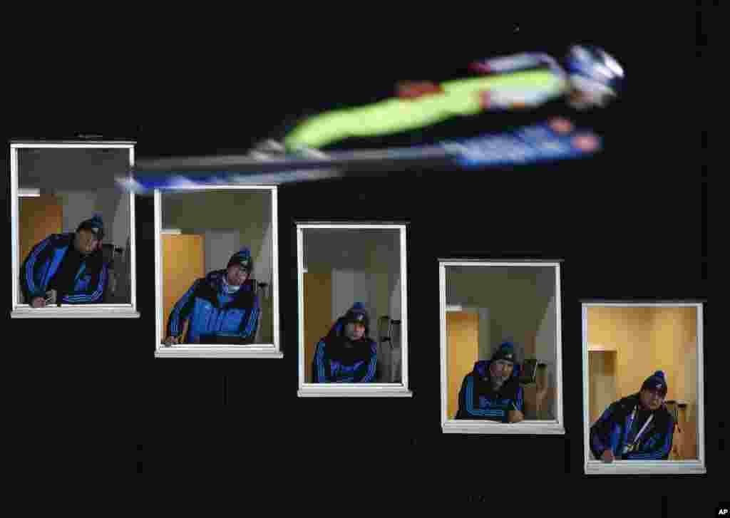 Sarah Hendrickson of United States jumps as judges look out of their tower windows during the Mixed Team Ski Jumping competition at the Nordic Skiing World Championships in Falun, Sweden.