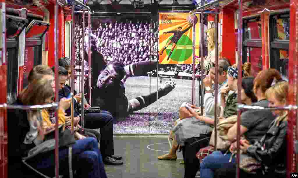 Commuters ride a World Cup-themed metro car decorated with a picture of Soviet goalkeeper Lev Yashin, in Moscow, ahead of the Russia 2018 World Cup football tournament.