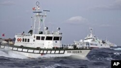 In this photo released by Taiwan's Central News Agency, a Taiwan Coast Guard patrol boat, front, comes in close proximity with a Japan Coast Guard patrol boat near the disputed islands called Senkaku in Japan and Diaoyu in China, in the East China Sea, Se