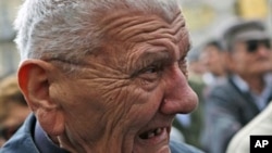 A man reacts as he watches a live broadcast of the verdict from the Yugoslav war crimes tribunal in The Hague in Zagreb, Croatia, April 15, 2011