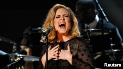 FILE - Adele performs "Rolling in the Deep" at the 54th annual Grammy Awards in Los Angeles, Calif.