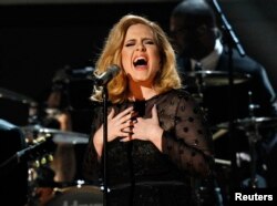 FILE - Adele performs "Rolling in the Deep" at the 54th annual Grammy Awards in Los Angeles, Calif.