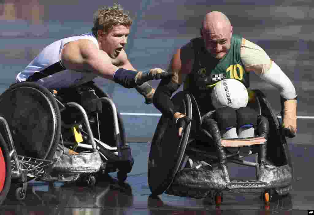 New Zealand&#39;s Cameron Leslie, left, tries to stop Australia&#39;s Chris Bond during the Wheelchair Rugby Tri-Nations match in Sydney. Australia won the match 57-41. 