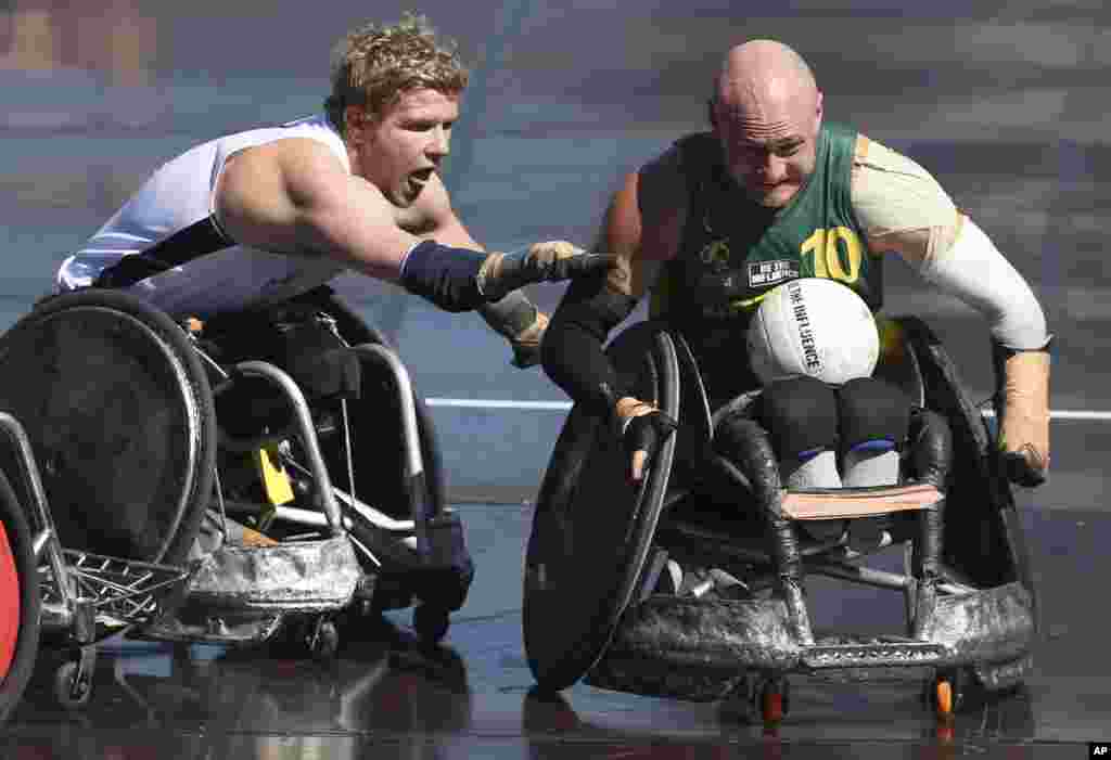New Zealand's Cameron Leslie, left, tries to stop Australia's Chris Bond during the Wheelchair Rugby Tri-Nations match in Sydney. Australia won the match 57-41.