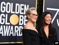 FILE - Meryl Streep, left, and Ai-jen Poo arrive at the 75th annual Golden Globe Awards at the Beverly Hilton Hotel in Beverly Hills, California, Jan. 7, 2018.