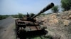 FILE - A tank damaged during the fighting between Ethiopia's National Defense Force and Tigray Special Forces stands on the outskirts of Humera, Ethiopia, July 1, 2021. 