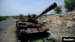 FILE - A tank damaged during the fighting between Ethiopia's National Defense Force and Tigray Special Forces stands on the outskirts of Humera, Ethiopia, July 1, 2021. 