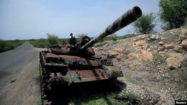 FILE - A tank damaged during the fighting between Ethiopia's National Defense Force and Tigray Special Forces stands on the outskirts of Humera, Ethiopia, July 1, 2021.