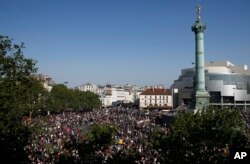 Protesters and activists gather at a square in Paris, May 5, 2018. Under the close watch of police, thousands of protesters in Paris danced, picnicked and railed against President Emmanuel Macron at a "party" marking his first year in office.