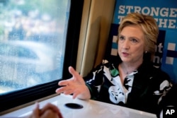 Democratic presidential candidate Hillary Clinton speaks on her campaign bus after visiting Imani Temple Ministries in Cleveland, 2016.