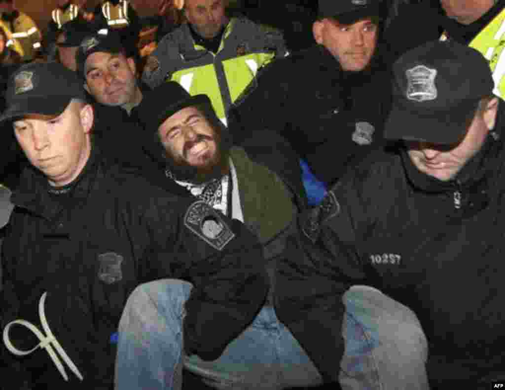 Boston police officers remove an Occupy Boston protester from Dewey Square in Boston before dawn Saturday, Dec. 10, 2011. More than 40 people were peacefully arrested as the park was cleared. The city had set a Thursday midnight deadline for protesters to