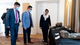Afghan Ambassador to the U.S. Roya Rahmani, right, accompanied by embassy staff, speaks as she gives the Associated Press a tour at the Afghanistan Embassy in Washington, Wednesday, April 21, 2021