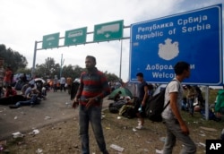 People rest at a makeshift camp at the Horgos border crossing into Hungary, near Horgos, Serbia, Sept. 16, 2015.