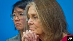 FILE - Gloria Steinem, right, and Christine Ahn of of WomenCrossDMZ listen during a U.N. news conference announcing plans for a women's walk across the demilitarized zone between North and South Korea to call for reunification, March 11, 2015. 