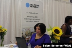 Nichelle Smith, features editor at USA Today Network National News Desk, mans a booth at the National Association of Black Journalists and the National Association of Hispanic Journalists in Washington, Aug. 3, 2016.