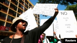 Women protest outside the Pretoria Magistrates court, during the bail application hearing of South African athlete Oscar Pistorius, February 19, 2013.