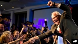 FILE - Tim Walz celebrates being elected to his first term as Minnesota's governor, in St. Paul, Minnesota, Nov. 6, 2018.