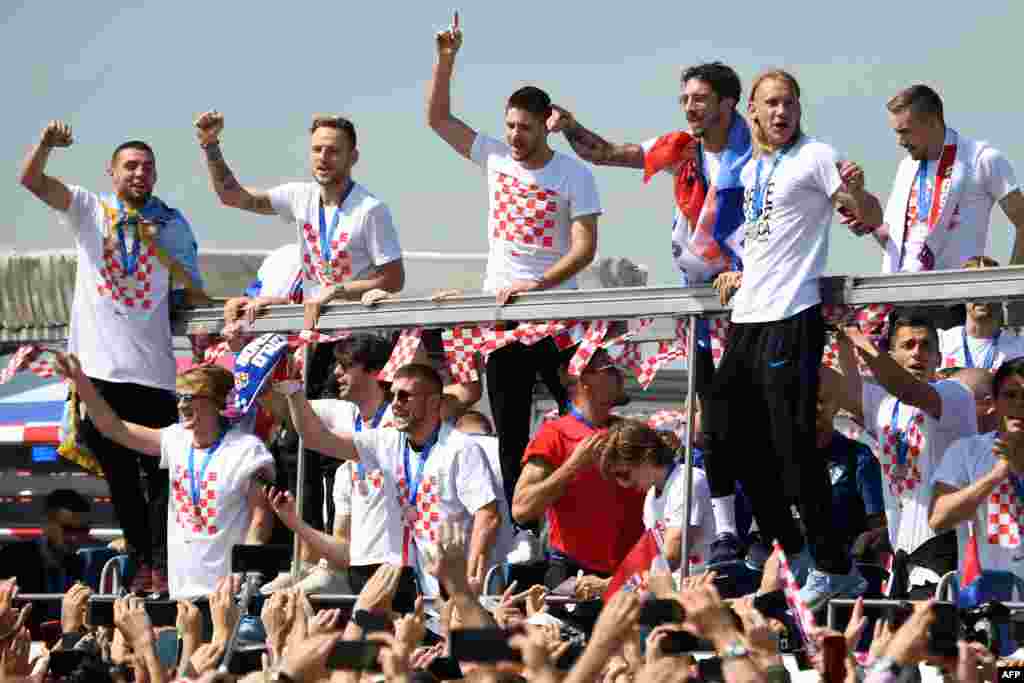Croatian national football team members ride an open-roof coach in Zagreb International Airport on July 16, 2018 after their return from the FIFA World Cup 2018 in Russia in Zagreb International Airport.