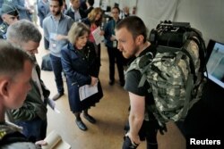 Visitors looks at the lightweight undersuit to reduce injuries & fatigue equipment during the DARPA (Defense Advanced Research Projects Agency) Demo Day exhibition at the Pentagon in Washington, May 11, 2016.