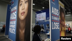 A visitor passes an exhibition at the International AIDS 2012 Conference in Washington