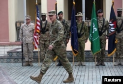 FILE - Commander of NATO Resolute Support forces and United States forces in Afghanistan, U.S. Army General John Nicholson walks during a change of command ceremony in Resolute Support headquarters in Kabul, Afghanistan, March 2, 2016.