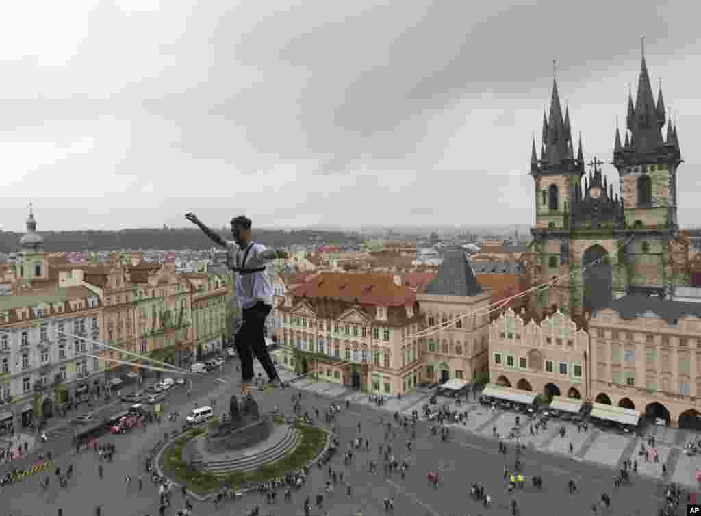 An athlete balances on a slackline stretched across the Old Town Square in Prague, Czech Republic. The performance was part of a campaign supporting people living with diabetes.