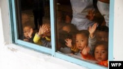 북한 삼촌 보육원에서 손을 흔들고 있는 아이들. 