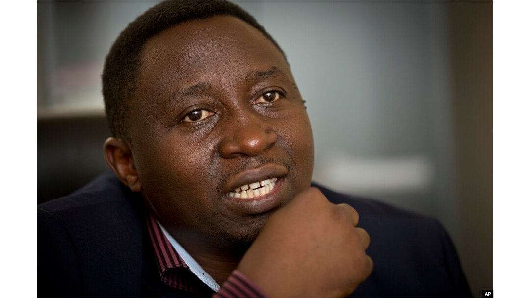 FILE - Frank Habineza speaks to a reporter at his offices in Kigali, Rwanda, March 25, 2014.