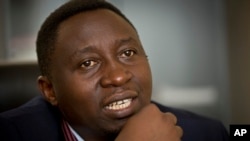 FILE - Frank Habineza, the leader of Rwanda's only opposition political party the Democratic Green Party of Rwanda, speaks to a reporter at his offices in Kigali, Rwanda.