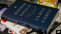 A copy of former FBI Director James Comey's new book, "A Higher Loyalty: Truth, Lies and Leadership," is on display, April 13, 2018, in New York. 