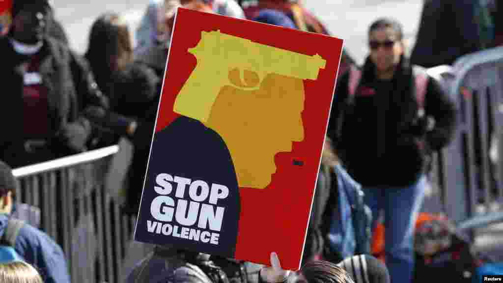 華盛頓反槍支暴力集會的參加者舉起標語牌