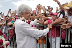 Mexican presidential candidate Andres Manuel Lopez Obrador greets supporters during a campaign rally, in Cancun, June 26, 2018.