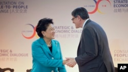 អនុ​រដ្ឋ​មន្រ្តី​ចិន Liu Yandong (រូប​ឆ្វេង) និង​រដ្ឋ​មន្រ្តី​រតនាគារ​ជាតិ​អាមេរិក Jack Lew ចាប់​ដៃ​នៅ​លើ​ឆាក​នៅ​ក្នុង​កិច្ច​សន្ទនា​សេដ្ឋកិច្ច​ និង​យុទ្ធសាស្រ្ត​អាមេរិក​និង​ចិន​លើក​ទី​៧ (7th US china Strategic and Economic Dialogue (S & ED) នៅ​ឯ​ក្រសួង​ការ​បរទេស​អាមេរិក​ក្នុង​រដ្ឋធានី​វ៉ាស៊ីនតោន កាលពី​ថ្ងៃទី២៣ ខែមិថុនា ឆ្នាំ២០១៥។