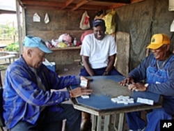 Gardeners playing dominoes at Greater Watts Community Garden