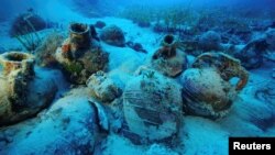 Amphorae are seen at the sea bottom at a shipwreck site on the island of Fournoi, Greece, September 15, 2018. Picture taken September 15, 2018. Vassilis Mentogiannis/Hellenic Ephorate of Underwater Antiquities/Handout via REUTERS 