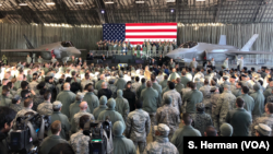 U.S. Vice President Mike Pence speaks to the troops gathered in a hangar at Yokota Air Base Japan, Feb. 8, 2018. A pair of U.S. Air Force F-35 jets flank the vice president.