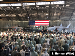 U.S. Vice President Mike Pence speaks to the troops gathered in a hangar at Yokota Air Base Japan, Feb. 8, 2018. A pair of U.S. Air Force F-35 jets flank the vice president.