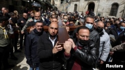 Christian worshippers take part in a Good Friday procession along the Via Dolorosa amid eased coronavirus disease restrictions, during Easter Holy Week in Jerusalem's Old City April 2, 2021. (REUTERS/Ammar Awad)