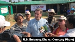 USAID Administrator Mark Green, center, speaks to reporters at the Balukhali Rohingya refugee camp in Cox’s Bazar, Bangladesh, May 15, 2018.
