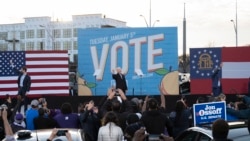 Democratic candidates for Senate Jon Ossoff (L), Raphael Warnock (R) and US President-elect Joe Biden (C) wave from stage during a rally outside Center Parc Stadium in Atlanta, Georgia, on January 4, 2021. - President Donald Trump, still seeking ways to r