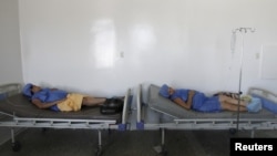 Pregnant women lay on beds without sheets during their labor at a maternity hospital in Maracaibo, Venezuela, June 19, 2015.