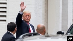 FILE - Republican presidential candidate Donald Trump waves as he arrives for a meeting with House Speaker Paul Ryan of Wis., at the Republican National Committee Headquarters on Capitol Hill in Washington, May 12, 2016. 