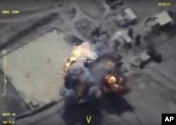 This frame grab provided Sept. 26, 2017, by the Russian Defense Ministry press service shows alleged militants positions being hit in Syria's Idlib province by Russia airstrikes.