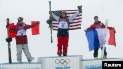 Canada's second placed Mike Riddle, first placed David Wise of the U.S. and France's third placed Kevin Rolland (L-R) celebrate on the podium after the men's freestyle skiing halfpipe finals at the 2014 Sochi Winter Olympic Games in Rosa Khutor, Russia, F