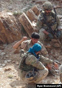 In this undated photo provided by Ryan Brummond, Mohammad Khalid Wardak, center, speaks to a U.S. solider in Afghanistan in Afghanistan