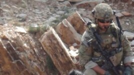In this undated photo provided by Ryan Brummond, Mohammad Khalid Wardak, center, speaks to a U.S. solider in Afghanistan in Afghanistan