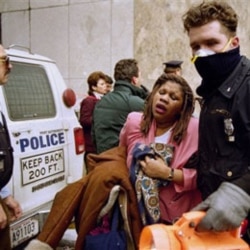 A New York City police officer helps a victim of the February 26, 1993, bomb attack at the World Trade Center