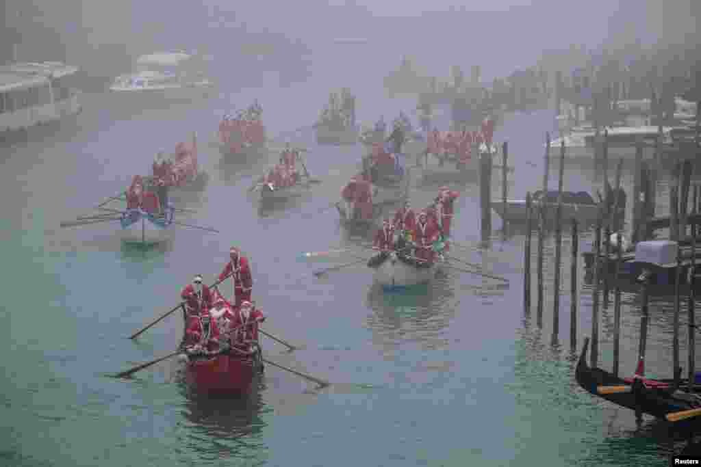 People dressed as Santa Claus row during a Christmas regatta in Venice, Italy.