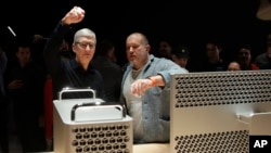 Apple CEO Tim Cook, left, and chief design officer Jonathan Ive look at a Mac Pro in the display room at the Apple Worldwide Developers Conference in San Jose, Calif., Monday, June 3, 2019. (AP Photo/Jeff Chiu)