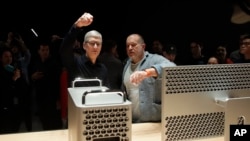 Apple CEO Tim Cook, left, and chief design officer Jonathan Ive look at a Mac Pro in the display room at the Apple Worldwide Developers Conference in San Jose, Calif., Monday, June 3, 2019. (AP Photo/Jeff Chiu)